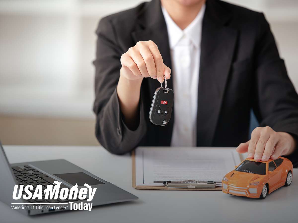 Tiny toy car and keys representing Auto Title Loans at a lender's desk