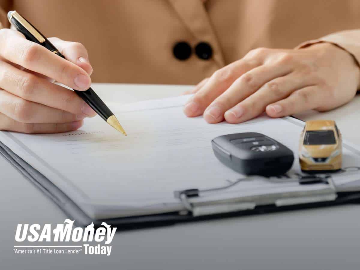 Signing paperwork for a Car Title Loan with keys and documents