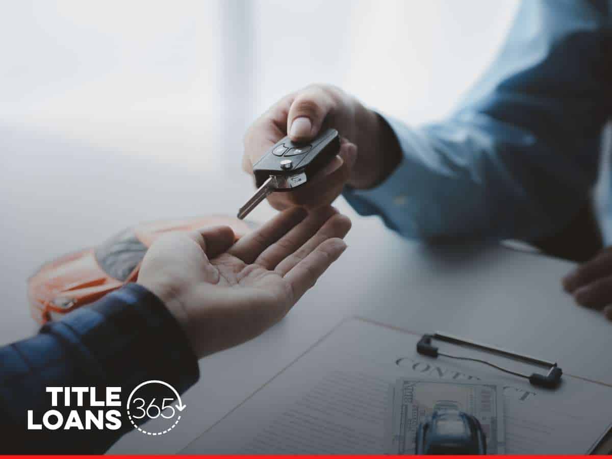 Handing over car keys for an RV Title Loan with contract and cash on table